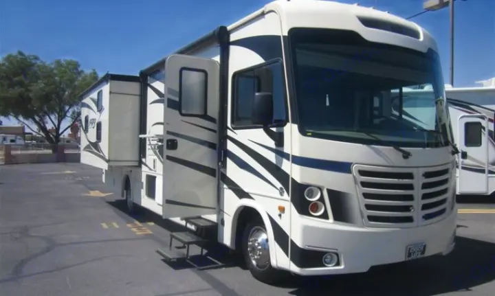 This white RV rental, with an extended slide-out and open entry, is parked on asphalt, ready for your next adventure.. Forest River Other 2020