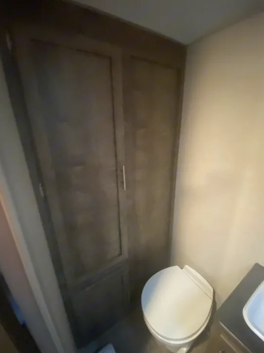 Inside an RV rental: a compact bathroom featuring a toilet, sink, and tall storage cabinets.. K-Z Manufacturing Sportsman Classic 2021
