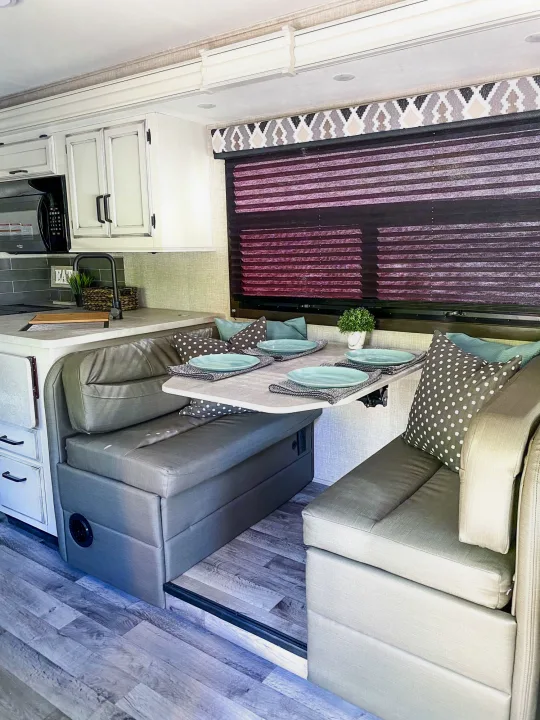 Cozy RV rental dinette and kitchen area with modern decor, ideal for travel adventures.. Entegra Coach Other 2022