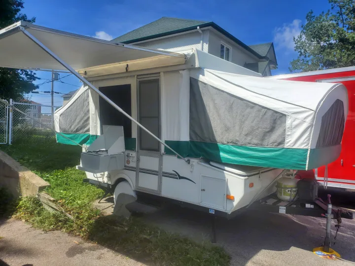 This pop-up RV rental features an extended awning, perfect for outdoor living.. Viking 1906st 2004