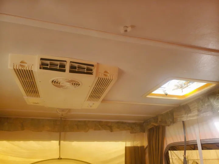 Overhead view inside an RV rental: air conditioner, ceiling fan, and fabric pop-up sections are visible.. Viking 1906st 2004