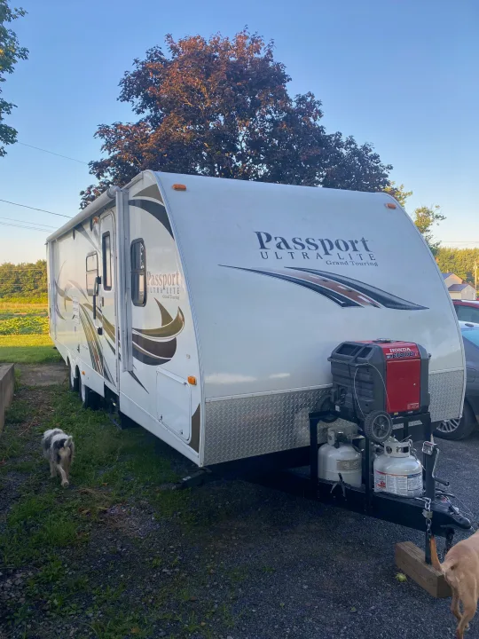 This white Passport Ultra Lite RV rental, equipped with a Honda generator, propane tanks, and two dogs, is ready for adventure.. Other Passport 2012