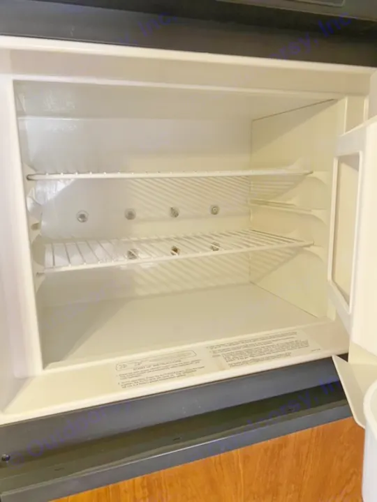 RV rental fridge interior: a clean, empty cooler compartment with dividers, ready for your trip.. Other Passport 2012