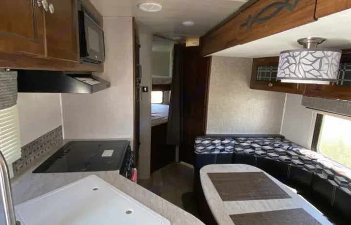 Explore this bright rv rental! Features a compact kitchen, comfortable dining area, and rear bunk beds, ideal for travel.. Heartland Other 2018