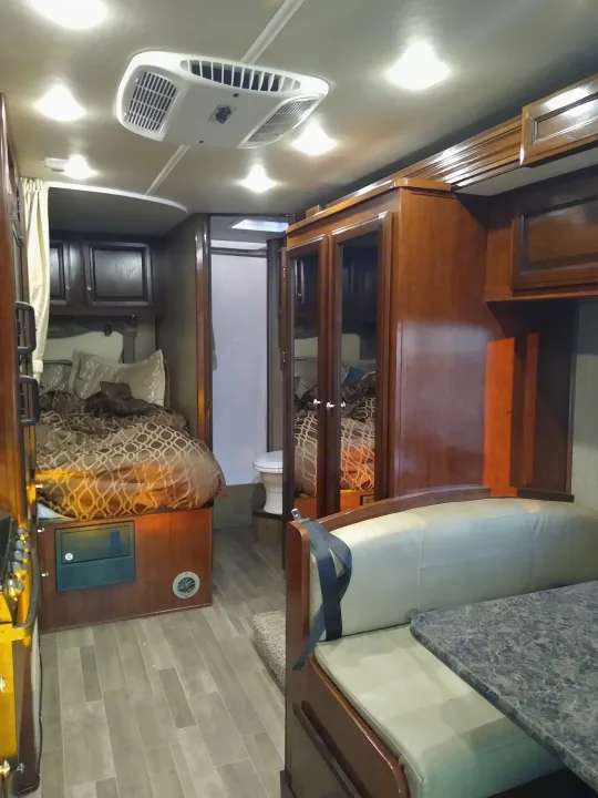 This cozy RV rental interior showcases a comfy bed, dinette, kitchen, and bathroom, perfect for your next trip.. Fleetwood Other 2018