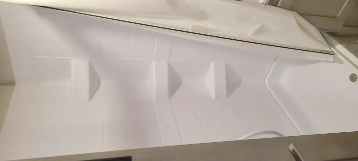 Clean, bright white RV shower stall, perfect for your RV rental adventure. Features textured walls & shower curtain.. Forest River All American Sport 2021