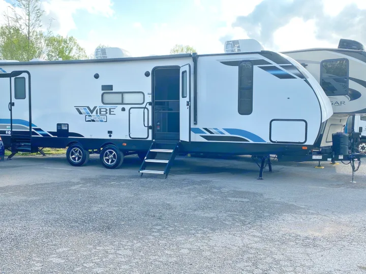 This Forest River Vibe travel trailer RV rental, with its door open and steps down, awaits adventure.. Forest River Vibe 2021