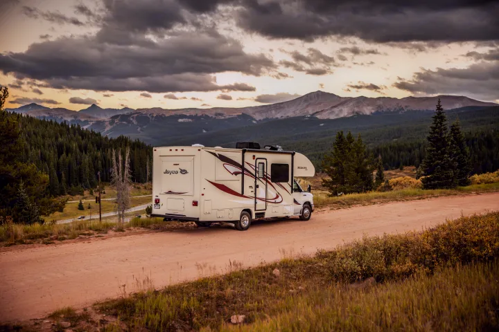 RV rental motorhome on a scenic dirt road, overlooking vast mountains and forests. Perfect for mountain travel & adventure.. Jayco Redhawk 2016