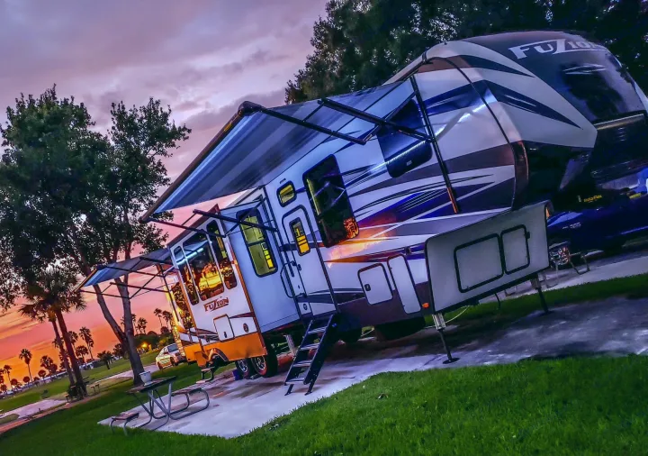 Luxury fifth-wheel RV rental at sunset. Enjoy stunning campground views on your next adventure!. Keystone Fuzion 2020