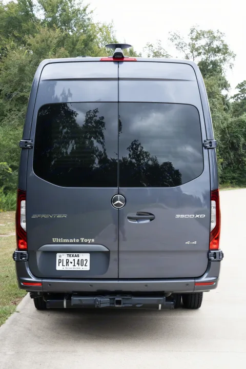 Back view of a grey Mercedes Sprinter rv rental, an Ultimate Toys 4x4 conversion, with Texas plate PLR-1402.. Ultimate Toys Ultimate Traveler 2022