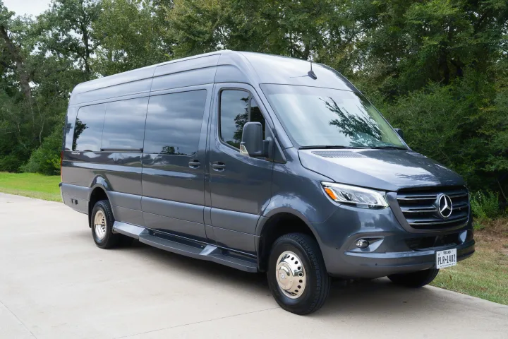 Luxury gray Mercedes-Benz Sprinter conversion van, ideal for rv rental, parked on concrete with trees behind.. Ultimate Toys Ultimate Traveler 2022