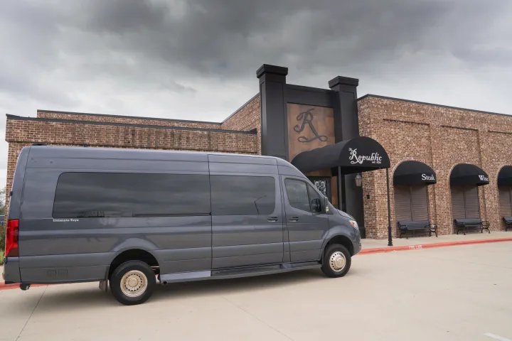 A gray Mercedes-Benz Sprinter luxury van, branded "Ultimate Toys", parked as an RV rental option outside The Republic restaurant.. Ultimate Toys Ultimate Traveler 2022