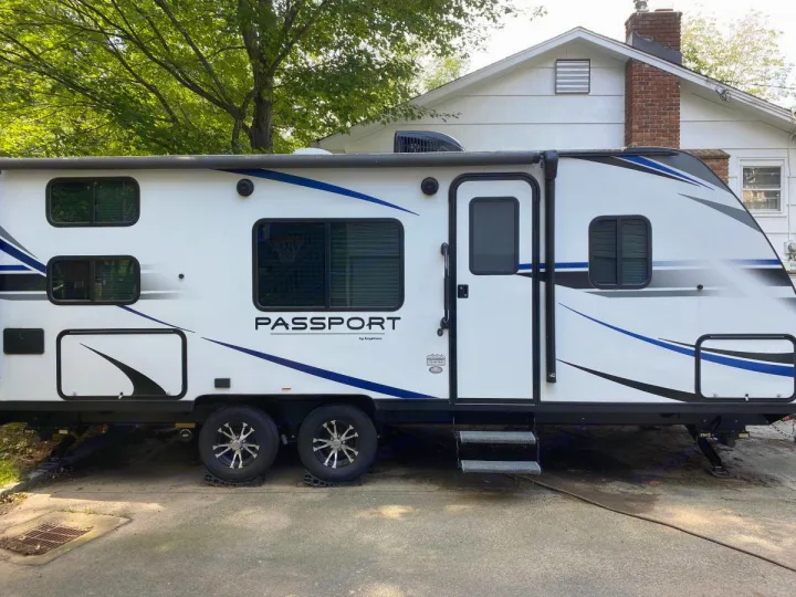 This modern Keystone Passport travel trailer, ideal for an RV rental, is parked and ready for adventure.. Other Passport 2020