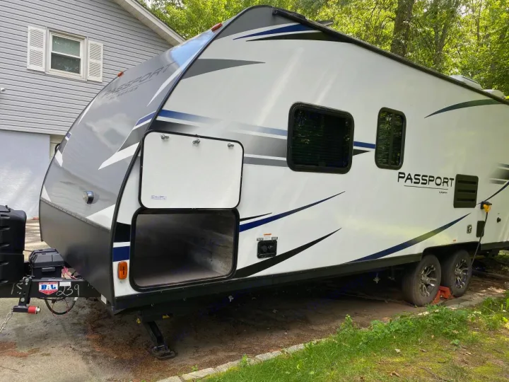 White & gray Passport recreational vehicle (RV) with open front storage. Ideal for your next rv rental.. Other Passport 2020