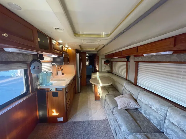 Inside this cozy RV rental: a full kitchen, comfy sofa, and dinette for your next adventure.. Foretravel U-320 2001