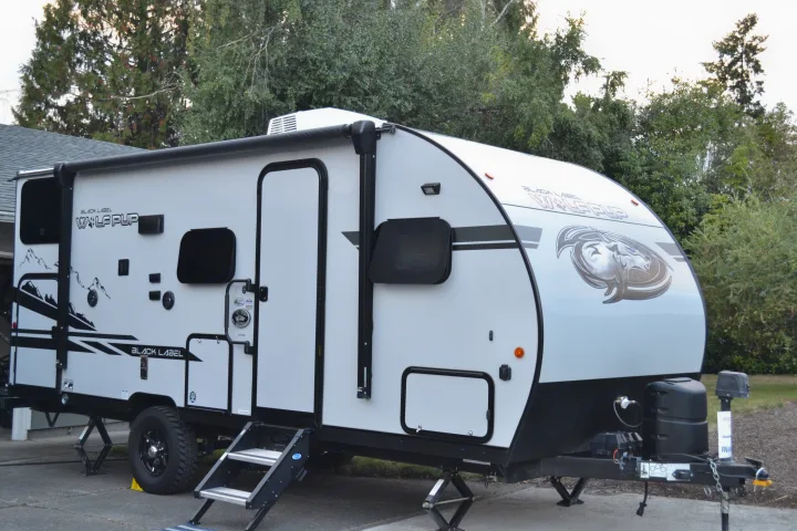This **RV rental**, a white Wolf Pup travel trailer, features an awning, steps, and leveling jacks.. Forest River Cherokee Wolf Pup 2020