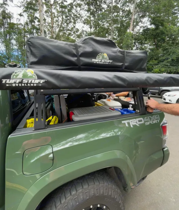 Overland-ready green truck with Tuff Stuff gear. A rugged RV rental option for camping adventures.. Toyota Tacoma 2021