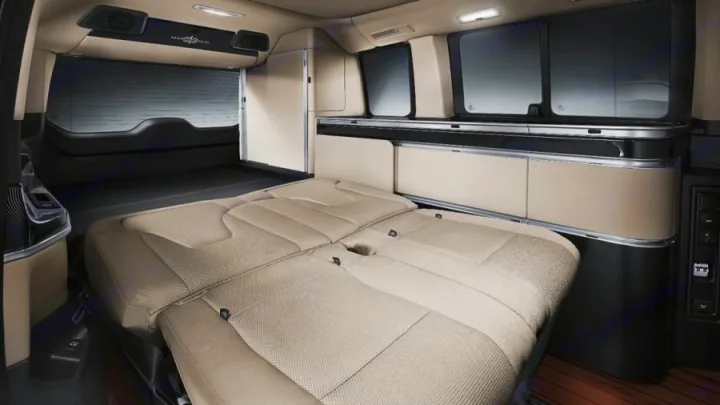 Inside a modern RV rental: rear seats fold into a spacious bed, with ample side storage & windows for comfortable travel.. Mercedes Class V Marco Polo 2021