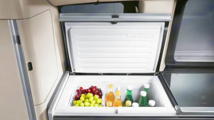 Spacious Westfalia RV rental cooler, stocked with fruit & drinks, part of a compact camper kitchen.. Mercedes Class V Marco Polo 2021