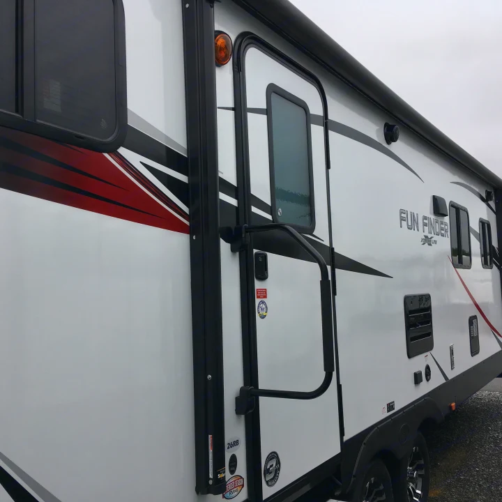 A modern white Fun Finder travel trailer, perfect for your next rv rental adventure, featuring stylish black and red accents.. Cruiser Rv Corp Fun Finder 2018