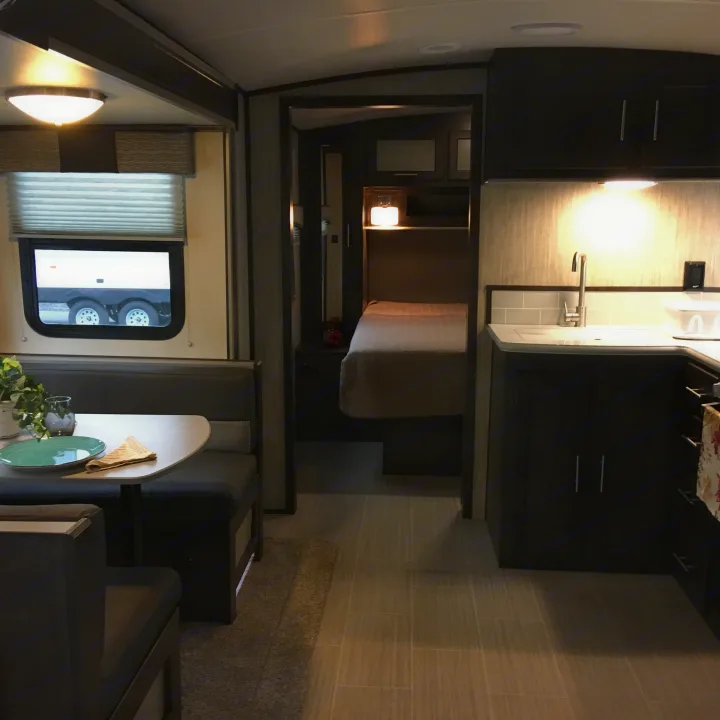 Modern RV rental interior featuring a bright kitchen, cozy bedroom, and comfortable dinette area.. Cruiser Rv Corp Fun Finder 2018