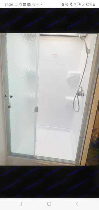 Modern RV rental shower: white walls, built-in shelf, textured glass sliding door. Clean and ready for travel.. Jayco Jay Flight 2019