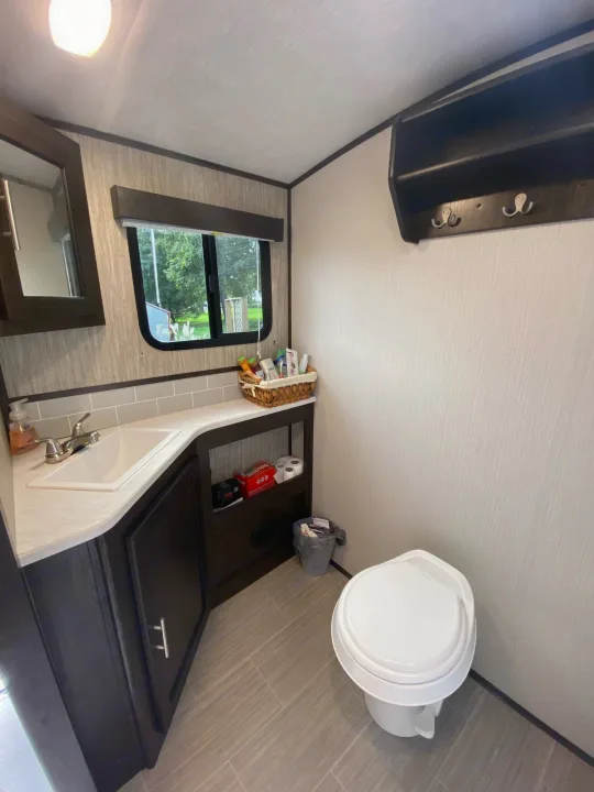 Inside an RV rental, this clean bathroom has a sink, toilet, counter, and a window for natural light.. Cruiser Rv Corp Fun Finder 2018