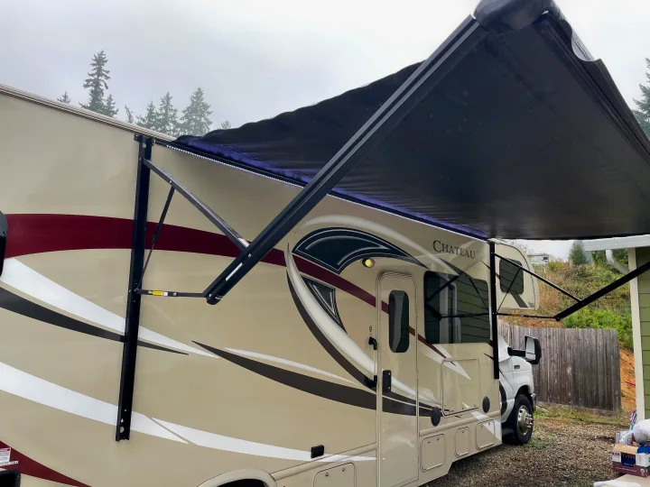 Class C Chateau RV rental with its black awning extended, showing LED lights underneath. Great for outdoor adventures.. Thor Motor Coach Chateau 2017