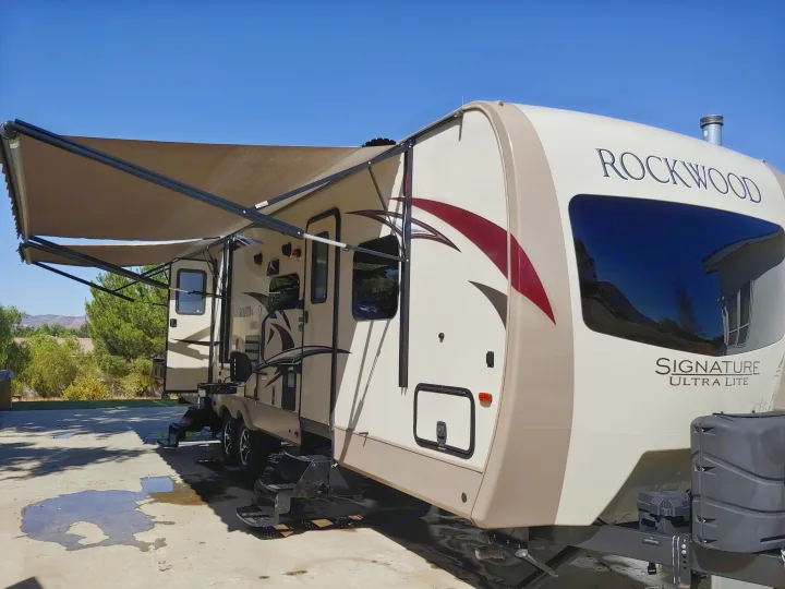 This Rockwood Signature Ultra Lite RV rental, with its extended awning, is ready for a relaxing sunny day adventure.. Forest River Rockwood Signature Ultra Lite 2017