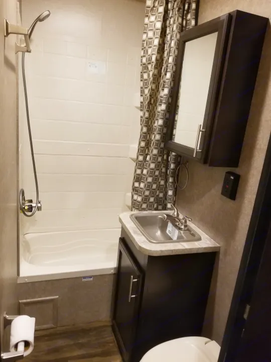 Explore this clean, compact RV rental bathroom: shower, sink, toilet, and mirrored cabinet. Everything you need on the go.. Jayco Octane 2017