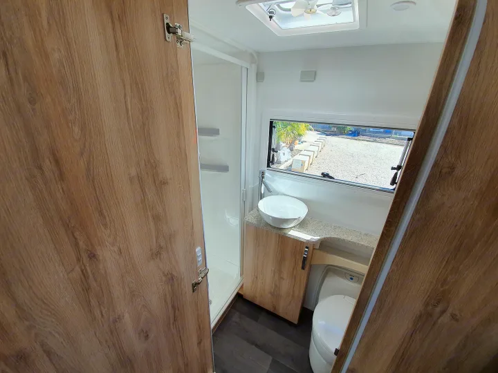This RV rental features a clean, modern bathroom with a standing shower, vanity with basin, toilet, and natural light.. Avan Aspire 617 Family 2021