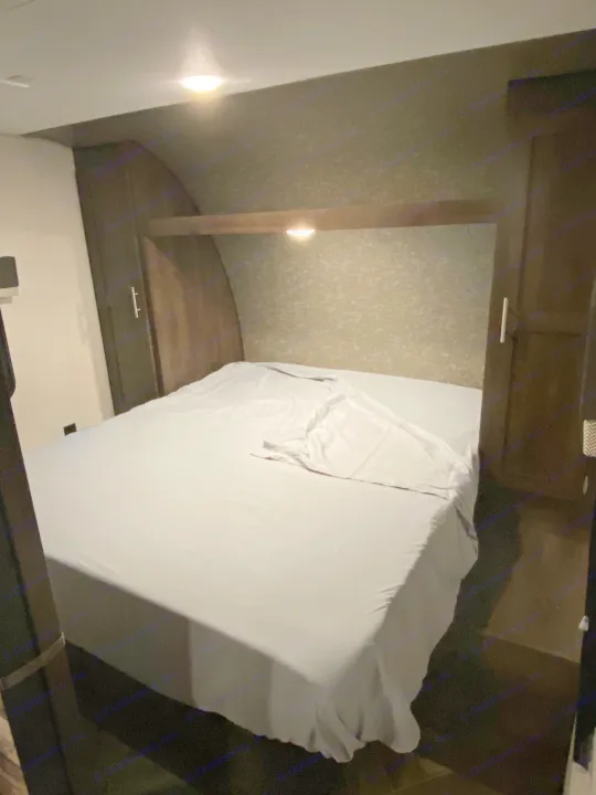 RV rental bedroom: cozy, compact, with built-in storage & soft lighting, perfect for travel.. K-Z Manufacturing Sportsmen 2021