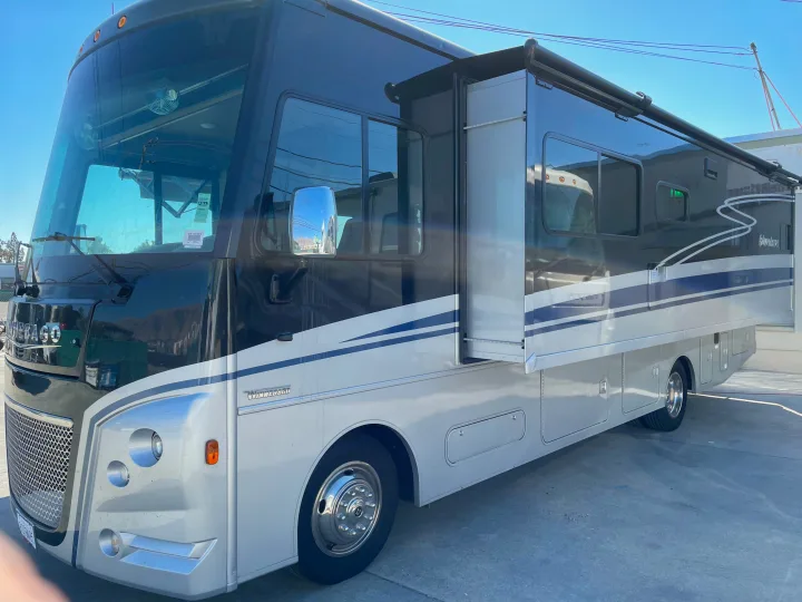This spacious black and white Winnebago Adventurer RV rental, with its slide-out extended, is ready for your next adventure.. Winnebago Adventurer 2022