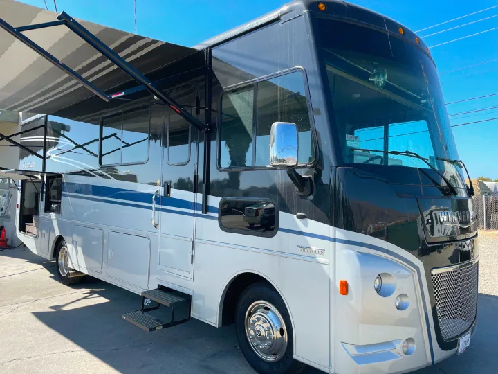 This sharp Winnebago Adventurer RV rental, with its extended awning and welcoming steps, awaits your next road trip.. Winnebago Adventurer 2022