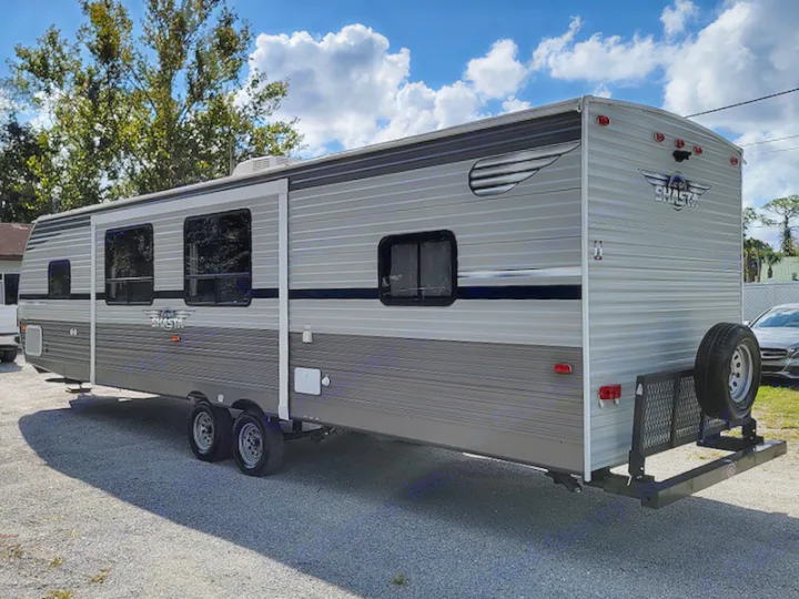 Your spacious gray travel trailer RV rental, a Shasta model, features a rear cargo rack & spare tire, ready for adventure.. Other Other 2021