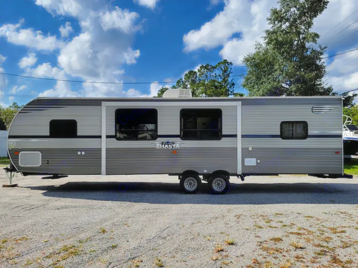 Spacious grey Shasta travel trailer on gravel. Perfect RV rental for your next outdoor camping adventure.. Other Other 2021