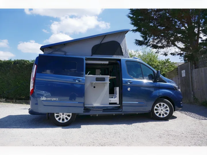Blue pop-top campervan with compact kitchen visible, ready for your RV rental adventure.. Ford Transit Custom 2+2 berth Pop Top, Manual 2022