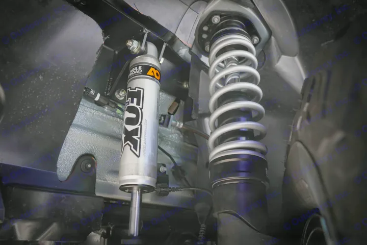 Close-up of a FOX Performance Series shock & coil spring, an Agile Offroad rv rental suspension upgrade.. Winnebago Revel 2019