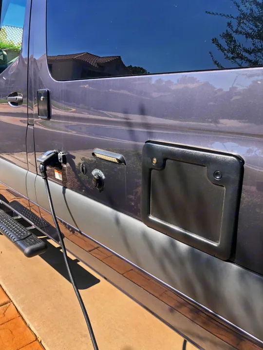 RV rental plugged in for shore power and city water fill. A side step is visible for access.. Mercedes-Benz 4x4 Sprinter mwb 2021