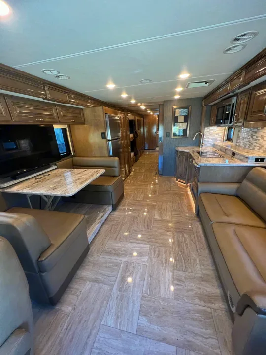Inside a luxurious RV rental: full kitchen, dining booth, comfy living space. Perfect for your next adventure!. Thor Motor Coach Aurora 2020