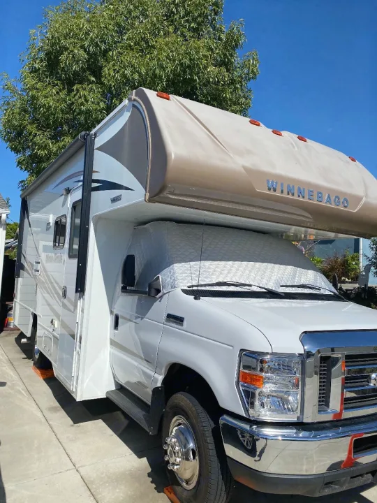 A white and gray Winnebago Class C RV with a sunshade, perfect for your next RV rental adventure.. Winnebago Minnie Winnie 2019