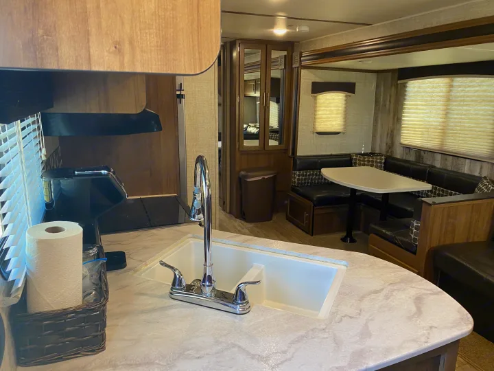 This RV rental features a full-size kitchen counter with a sink and coffee maker, plus a cozy dining booth for your trips.. Gulf Stream Trailmaster 2020