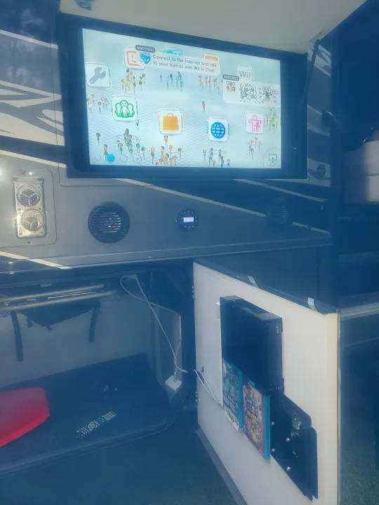 An RV rental features a full entertainment setup with a Nintendo Wii U, games, and speakers, perfect for travel gaming.. Forest River Georgetown GT7 2021
