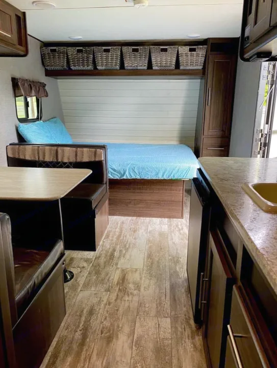 Step inside this RV rental! Features a comfy bed, dinette, kitchen, wood-look floor, and convenient overhead storage.. Crossroads Zinger 2018