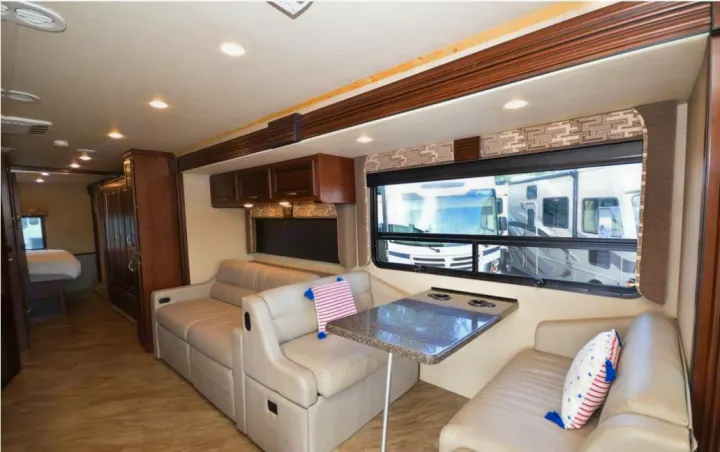 Bright and modern RV rental interior showing living, dining areas, and a glimpse of the bedroom.. Fleetwood Other 2017