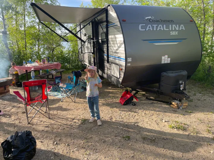 Our RV rental campsite: a Coachmen Catalina travel trailer, family, picnic, and a lakeside view.. Coachmen Catalina SBX 221TBS 2019
