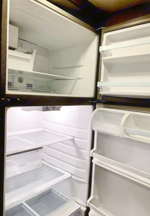 Inside an open, empty, and clean RV refrigerator with freezer, ready for your RV rental journey.. Thor Motor Coach Four Winds 2018