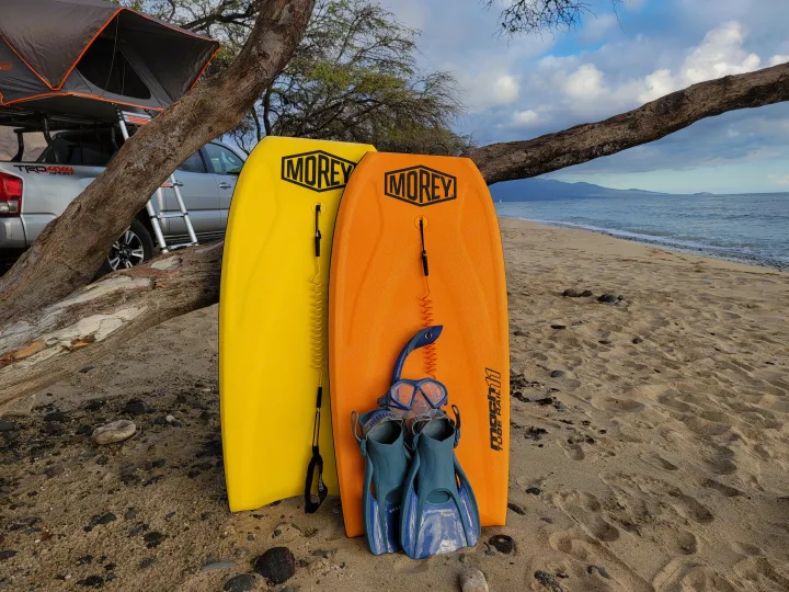 Beach fun with Morey boogie boards & snorkel gear by an RV rental-style truck with a rooftop tent, set on sandy shores.. Toyota Tacoma 2017