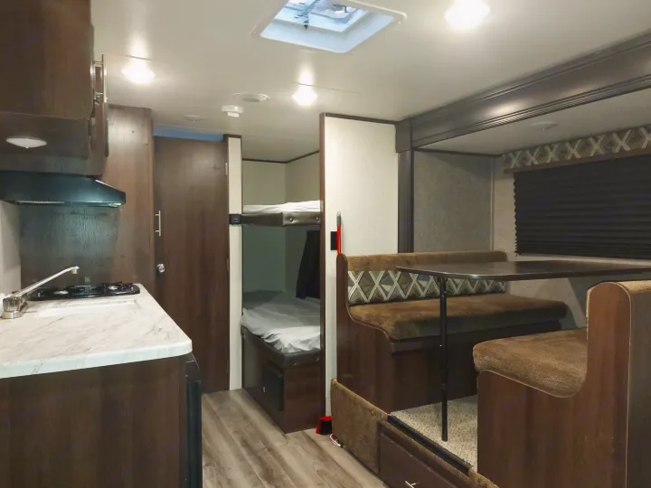 Spacious RV rental interior featuring a functional kitchen, cozy bunk beds, and a comfortable dinette area.. Jayco Jay Flight SLX 2019