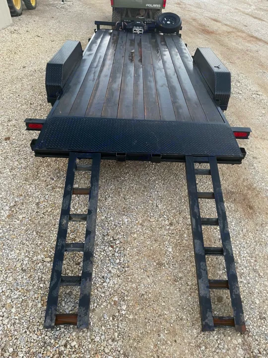 Black utility trailer with dual ramps, ideal for hauling. A versatile accessory for your next RV rental adventure.. Other Other 2020